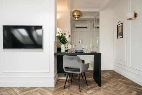 a dining room with a table and a chair at Central Palace - LoftAffair Collection in Kraków