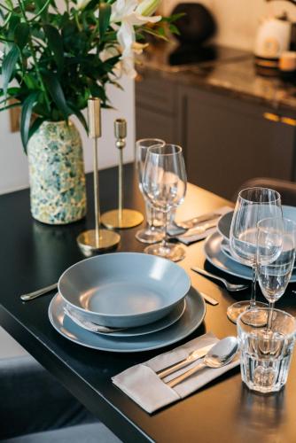 a table with plates and wine glasses on it at Central Palace - LoftAffair Collection in Kraków