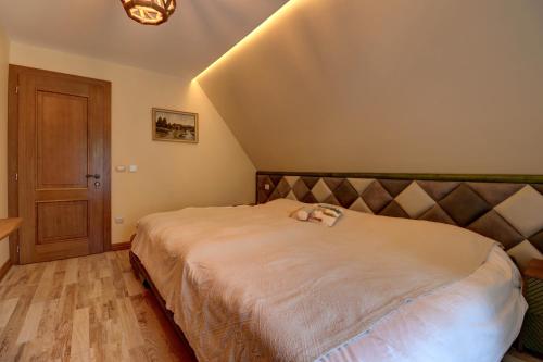 a bedroom with a large bed in a room at Captivating 3-Bed Villa in Brezovica Ski Centre in Brezovicë