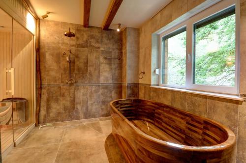 a bathroom with a wooden tub and a window at Captivating 3-Bed Villa in Brezovica Ski Centre in Brezovica