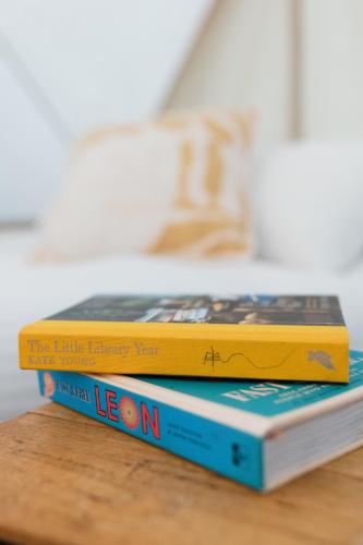 two books stacked on top of each other on a table at Goldfield Glamping in Clydesdale