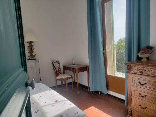 une chambre avec un lit, un bureau et une fenêtre dans l'établissement Maison entière avec un grand jardin à 15 min du centre en transports: bienvenue à QG Marseille !, à Marseille