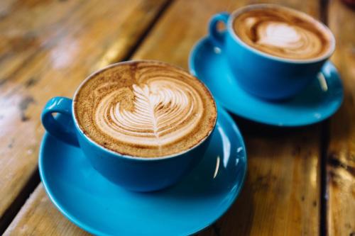 two blue cups of coffee on a wooden table at The Westin Portland Harborview in Portland