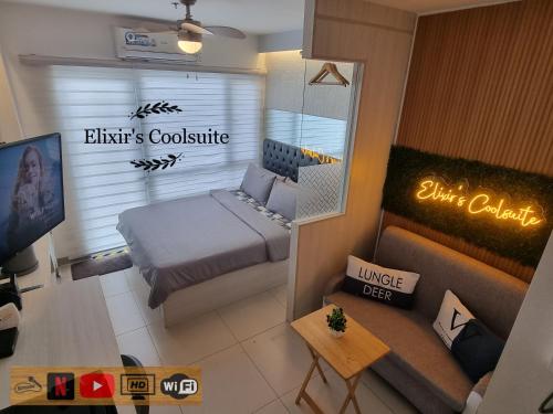 a small room with a bed and a mirror at Tagaytay affordable staycation by Elixir's Coolsuite in Tagaytay