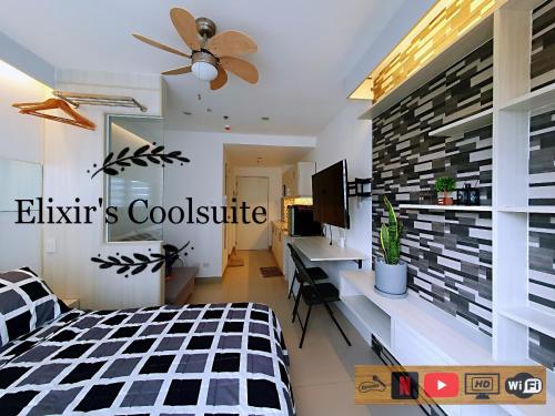a bedroom with a black and white checkered bed at Tagaytay affordable staycation by Elixir's Coolsuite in Tagaytay