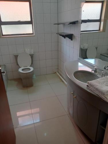 a bathroom with a toilet and a sink at Rizhatchguest in Mahikeng