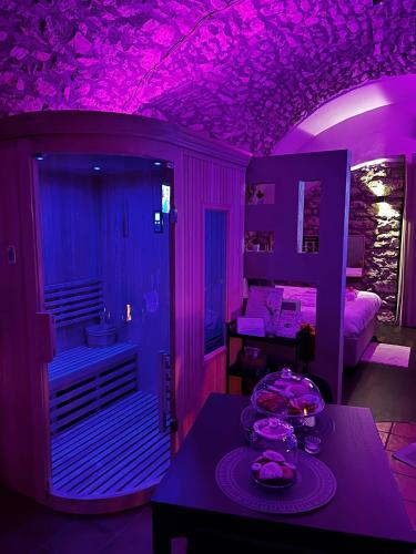 a purple room with a table with food on it at Vicolo72 in Calitri