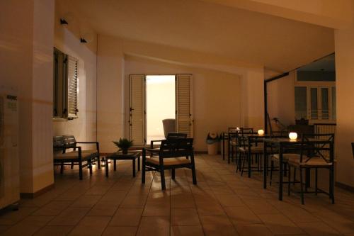 a room with tables and chairs and a room with a window at Lasso B&B in Corigliano Calabro
