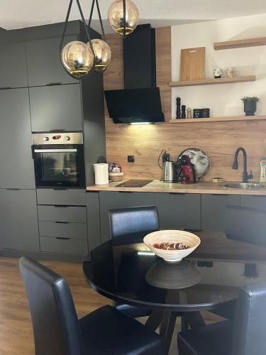 a kitchen with a table and chairs in a kitchen at Visage appointment in Strumica
