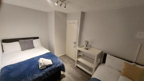 a small bedroom with a bed and a night stand at 2-Bed Apartment in King's Cross Central London in London