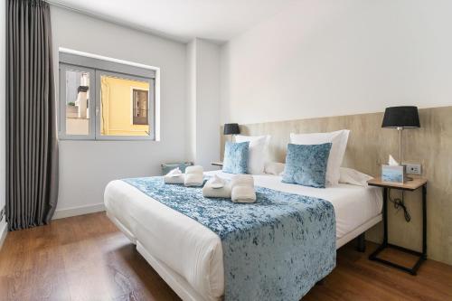 a bedroom with a large bed with blue and white at Sensation Sagrada Familia in Barcelona