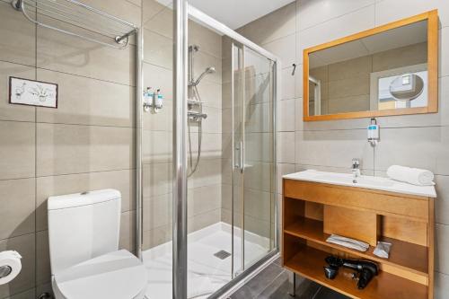 a bathroom with a shower and a toilet and a sink at Sensation Sagrada Familia in Barcelona