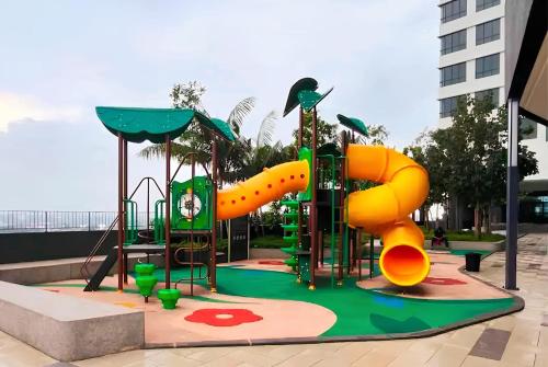 a playground with a slide in a park at Family Fun Staycation @ Thelima Suite in Kajang