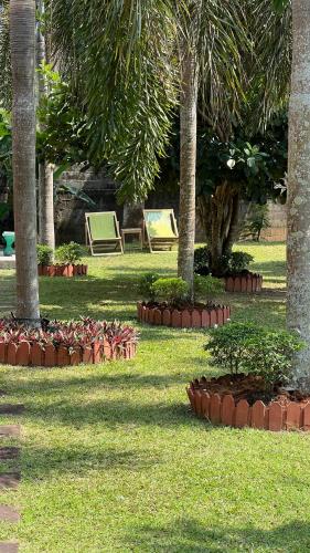 a park with palm trees and plants in the grass at Malinee Villa Phuket in Bang Tao Beach