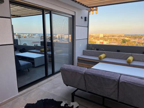 a living room with a couch and a large window at Sallam Lux Property in Hurghada