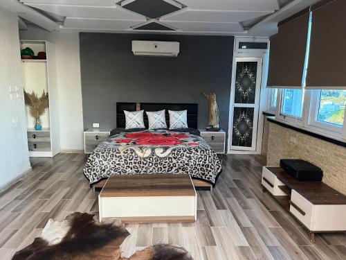 a bedroom with a bed with a black and white comforter at Sallam Lux Property in Hurghada