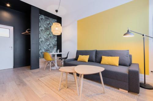 a living room with a blue couch and a table at Marcq-en-Baroeul - beautiful fully equipped ! 2p in Marquette-lès-Lille