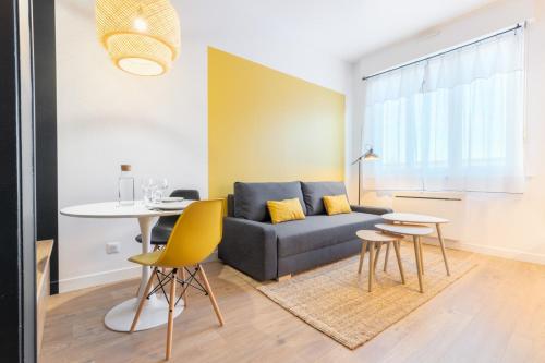 a living room with a couch and a table at Marcq-en-Baroeul - beautiful fully equipped ! 2p in Marquette-lès-Lille