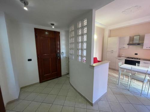 a kitchen with a counter and a table and a door at G&G Giusy e Gabry in Santhià
