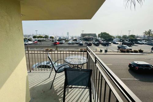 a balcony with a table and chairs and a parking lot at Ramada by Wyndham San Diego Airport in San Diego