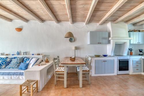 a living room with a couch and a table at Lefkes Village Living in Lefkes