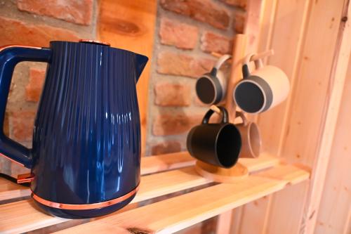a blue jug sitting on a shelf with utensils at VAL HILLS Rural Holiday House in Gaj Vrbovečki
