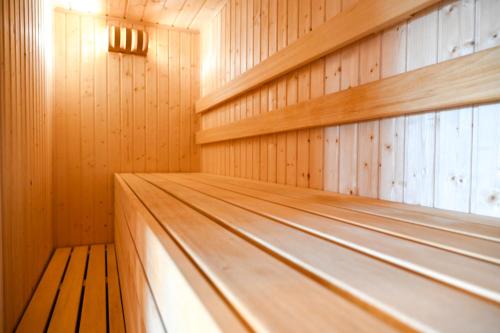 a sauna with wooden walls and a wooden floor at VAL HILLS Rural Holiday House in Gaj Vrbovečki