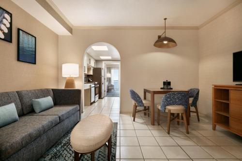 a living room with a couch and a table at Holiday Inn & Suites Ocean City by IHG in Ocean City