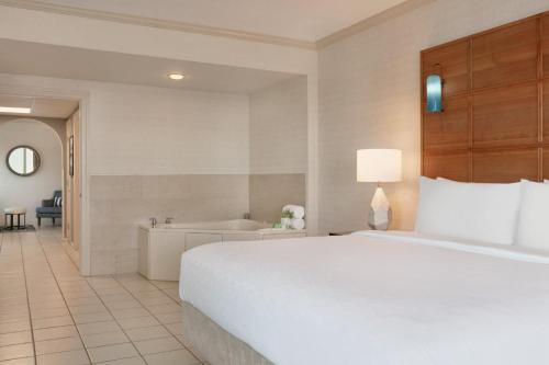 a hotel room with a bed and a bath tub at Holiday Inn & Suites Ocean City by IHG in Ocean City