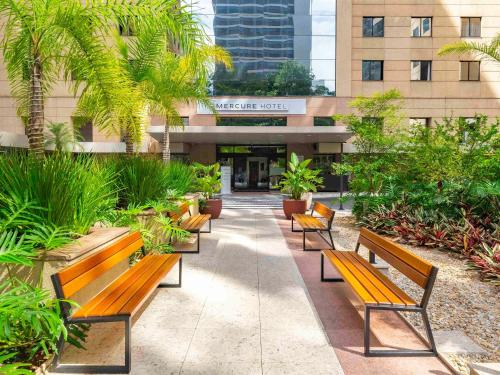 a row of benches in front of a building at Mercure Sao Paulo Moema Times Square in São Paulo