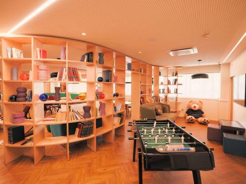a living room with a foosball table and shelves at Novotel Le Havre Centre Gare in Le Havre