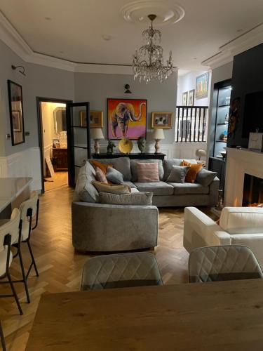 a living room with couches and a chandelier at East Cliff in Preston