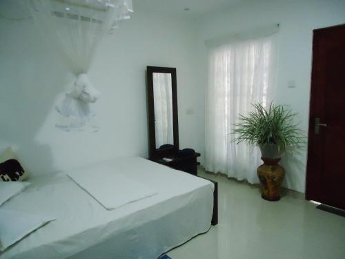 Letto o letti in una camera di Sigiri Rock Side Home Stay