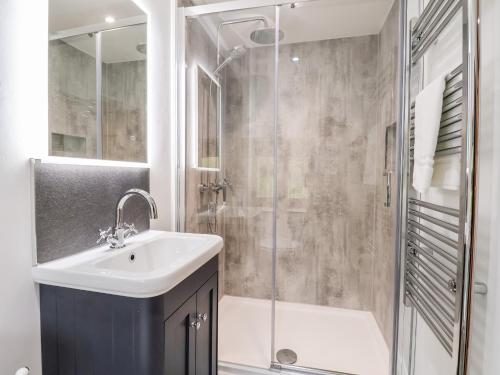 a bathroom with a sink and a shower at Rockhill Farmhouse in Craven Arms