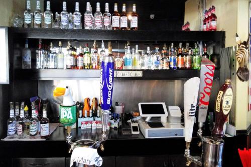 a bar with a lot of bottles of alcohol at Econo Lodge Ormond Beach North - Daytona in Ormond Beach