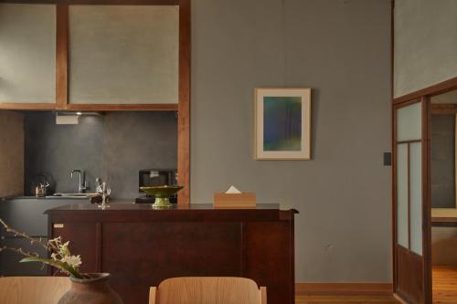 a kitchen with a table and a counter top at Lhotel de Mai in Tamba-sasayama