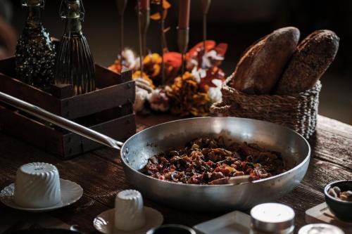 a bowl of food sitting on a table with bread at La pagliera in Agrigento
