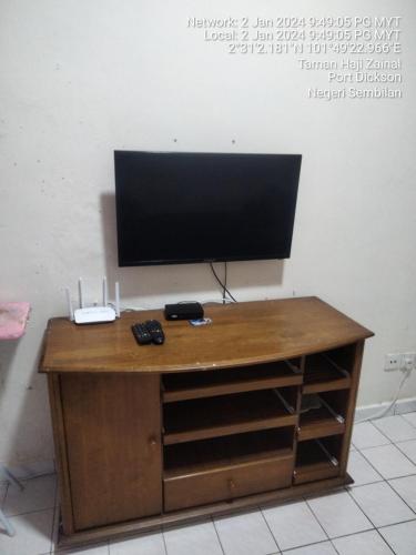 a wooden desk with a television on top of it at Seaview beach Corus Paradise pd in Port Dickson