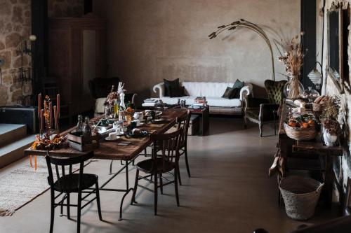 a living room with tables and chairs and a couch at La pagliera in Agrigento