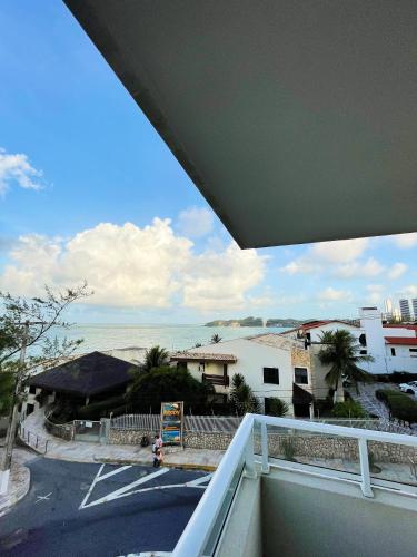 a view of the ocean from the balcony of a house at Liiv Mar - Natal Ponta Negra in Natal