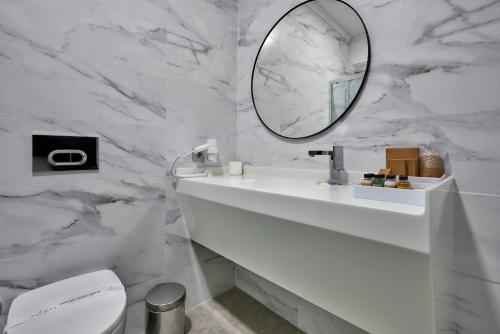 a white bathroom with a sink and a mirror at Joyway Hotels Istanbul Sultanahmet in Istanbul