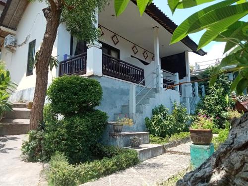 a house with stairs to the second floor at Sinar Bali 2 in Amed