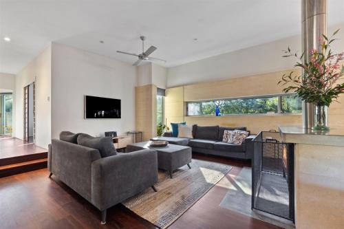 a living room with two couches and a tv at Banyandah - Dog Friendly - Family & Groups Welcome in Margaret River Town