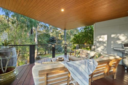 a patio with a couch and a table on a deck at Banyandah - Dog Friendly - Family & Groups Welcome in Margaret River Town