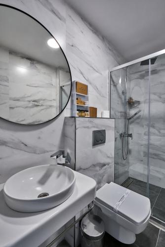 a white bathroom with a sink and a shower at Joyway Hotels Istanbul Sultanahmet in Istanbul