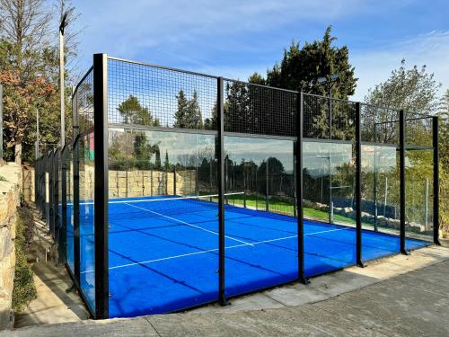 a tennis court with a net on it at The Village in Cerdanyola del Valles