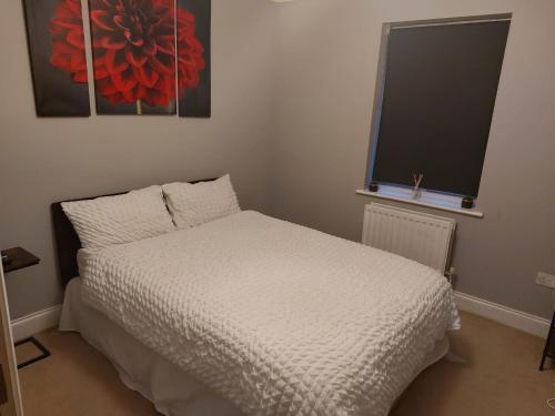 a small bedroom with a bed and a window at Short Stay at Dartford!!! in Dartford