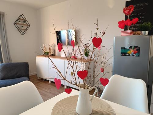 a vase with hearts on a table in a living room at Holiday home Vinovilla in Kutjevo