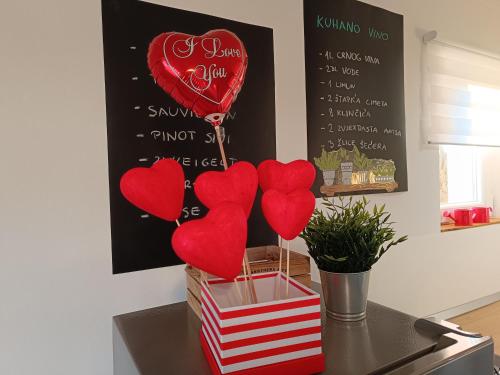 a table with red hearts on a chalkboard at Holiday home Vinovilla in Kutjevo