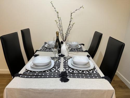 a dining room table with a black and white table cloth at Peaceful Coventry Retreat - Free parking in Coventry